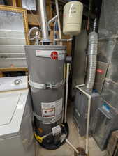 Utility area featuring a water heater, expansion tank, and furnace