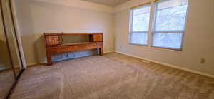 Unfurnished bedroom featuring carpet floors and baseboards