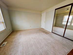 Carpeted empty room with baseboards