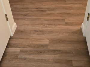 Detailed view of wood finished floors and baseboards