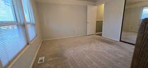 Unfurnished bedroom with carpet floors and a closet