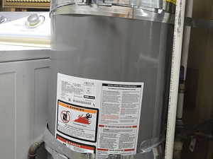 Utilities featuring strapped water heater and washer / dryer