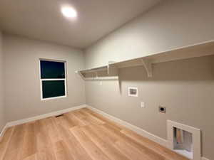Laundry room featuring light wood finished floors, hookup for a washing machine, and electric dryer hookup