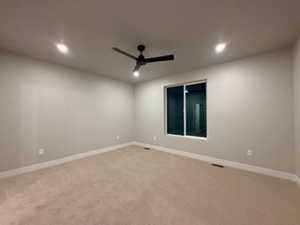 Unfurnished room with a ceiling fan, light carpet, and recessed lighting