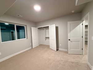 Unfurnished bedroom with carpet and a closet