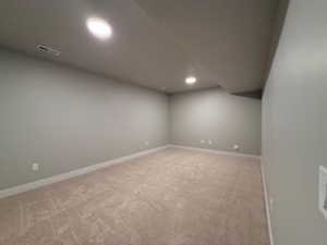 Unfurnished room with light carpet and recessed lighting