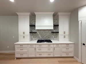 Kitchen featuring open shelves, white cabinetry, light countertops, and recessed lighting