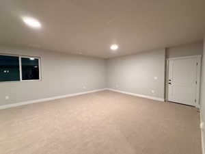 Spare room featuring light carpet and recessed lighting