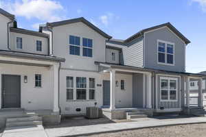View of front of property with brick siding and a porch