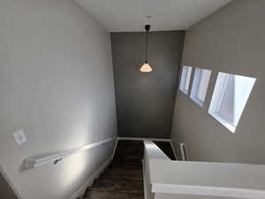 Staircase featuring wood finished floors and baseboards