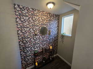 Detailed view of wood finished floors and a textured ceiling