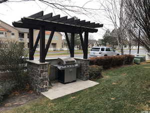View of patio / terrace featuring a pergola, grilling area, and a residential view
