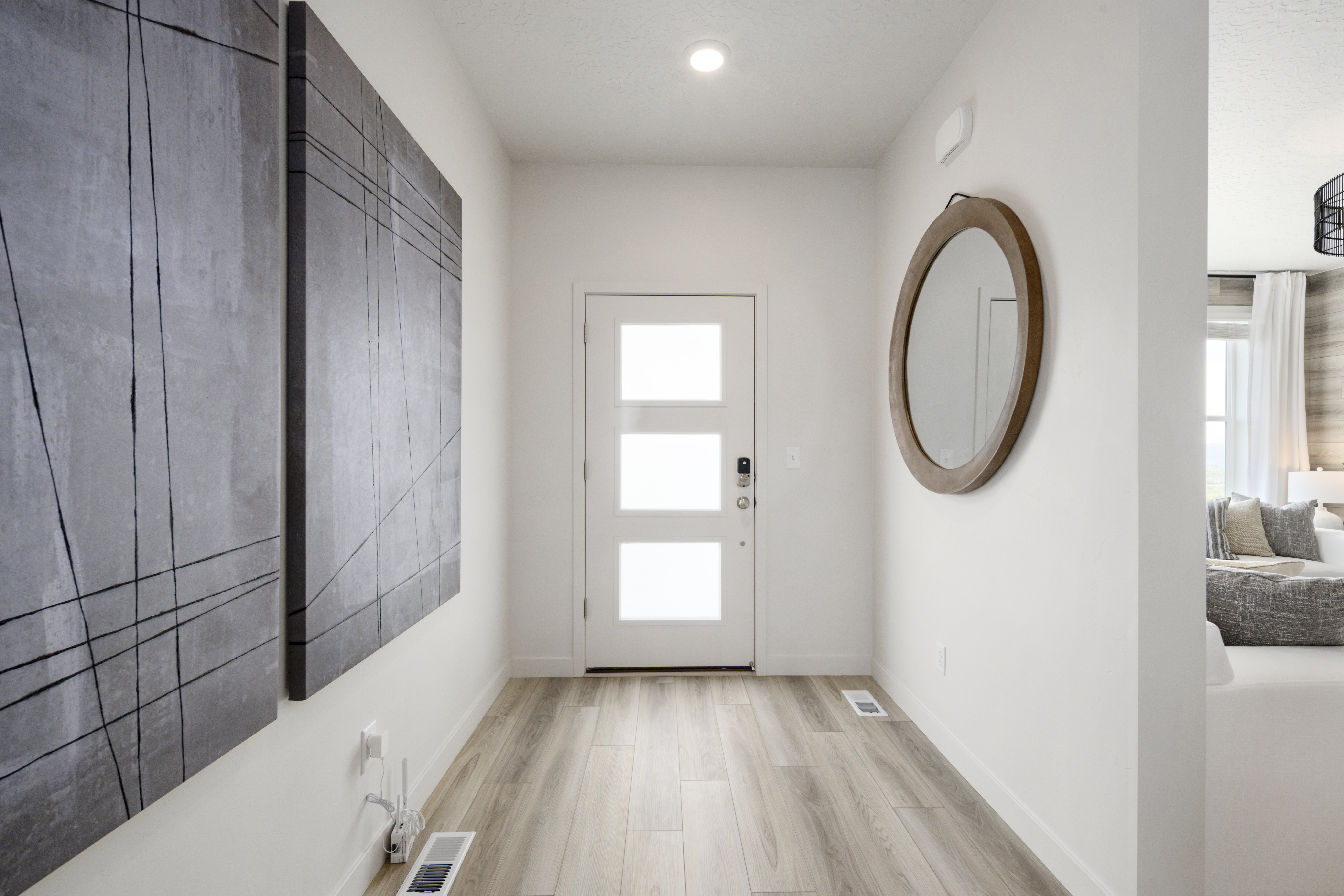 Entryway with light wood finished floors and baseboards