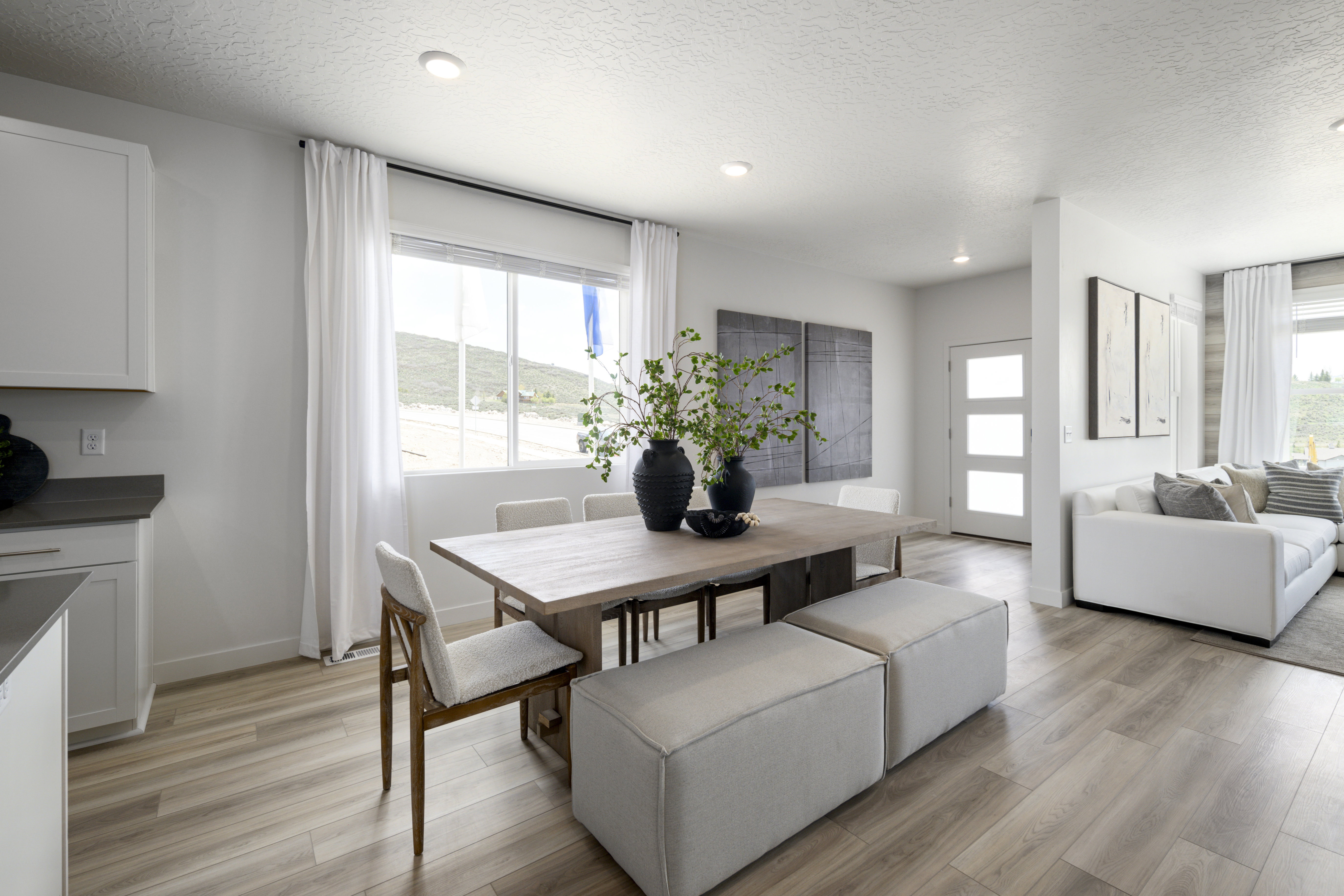 Dining space featuring a textured ceiling, light wood-style flooring, and recessed lighting
