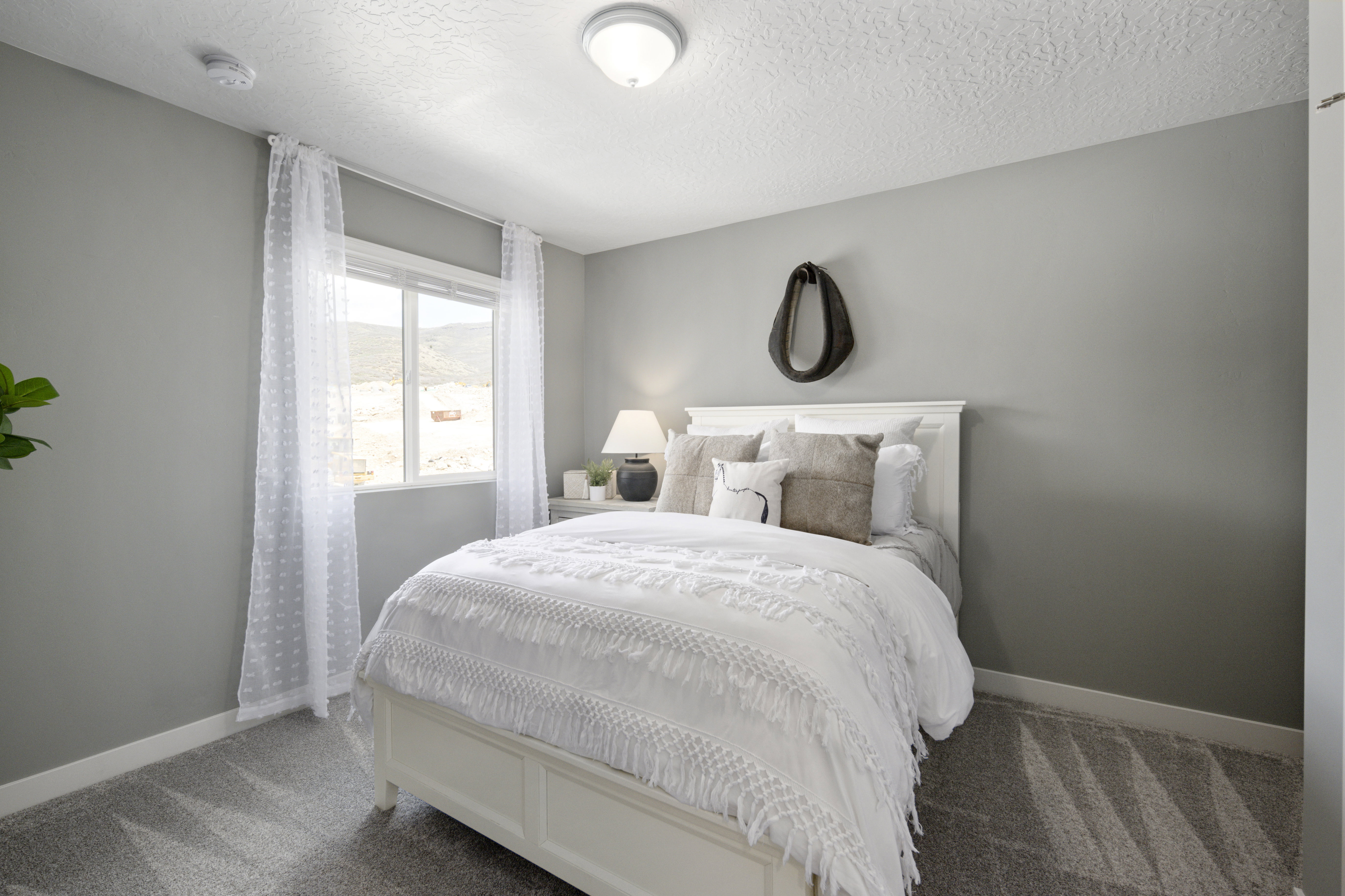 Carpeted bedroom featuring baseboards and a textured ceiling