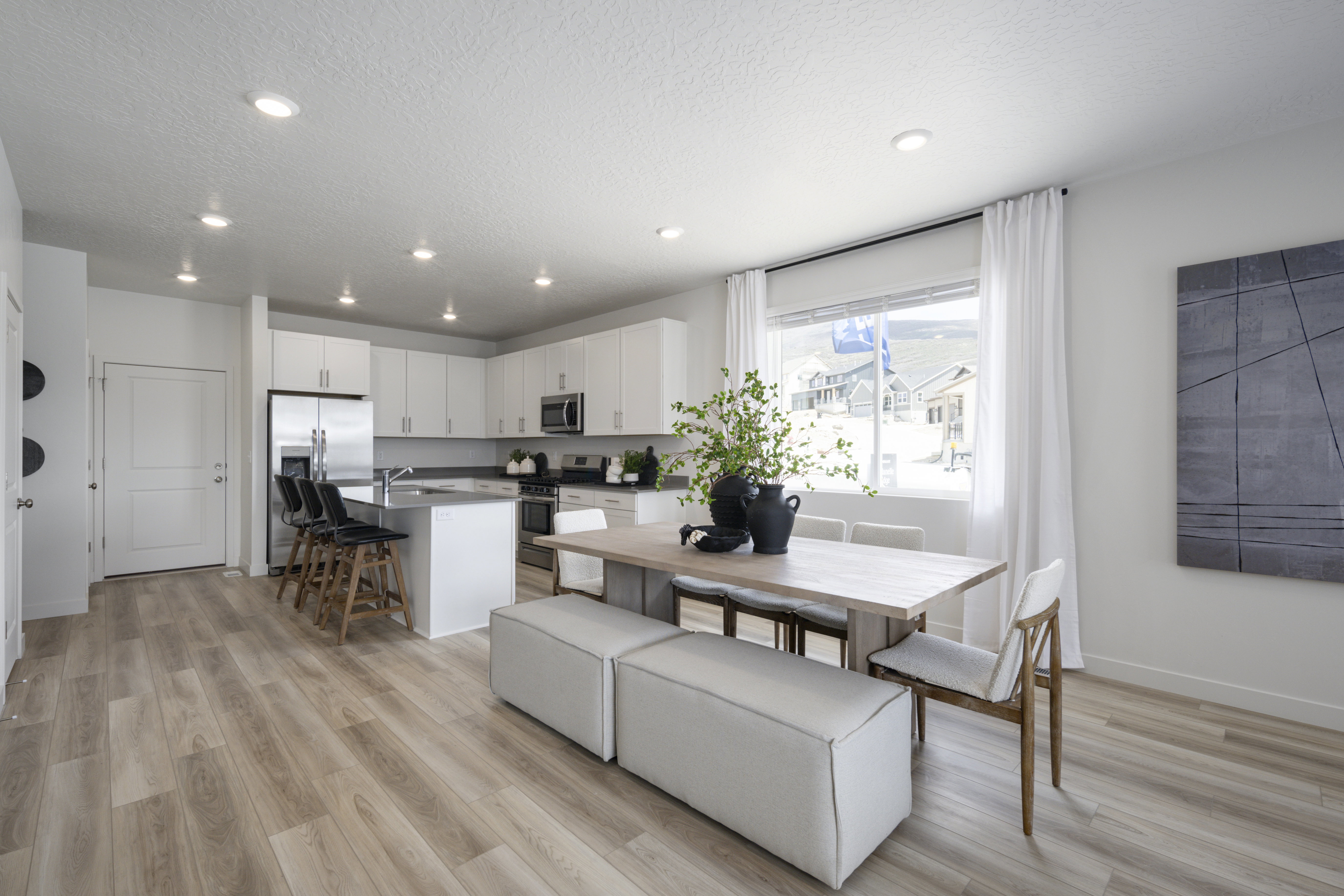 Dining space featuring light wood-style floors, recessed lighting, and a textured ceiling