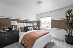 Bedroom with carpet and a textured ceiling