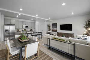 Dining area featuring recessed lighting, light wood-style flooring, and a textured ceiling