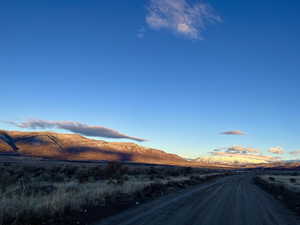 View of dirt / gravel road with a mountain view