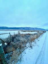 Water view with mountains fenced corner of property