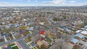 Aerial view of property and surrounding area featuring nearby suburban area