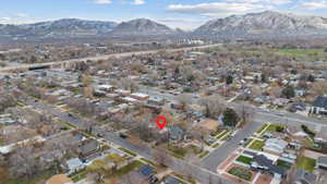 Aerial view of property's location featuring mountains and nearby suburban area