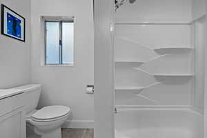 Bathroom featuring a stall shower, vanity, and light wood-type flooring