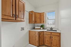 Laundry room with washer hookup and cabinet space