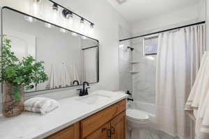 Full bath with vanity and shower / tub combo with curtain
