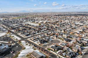 Aerial view of property and surrounding area featuring nearby suburban area