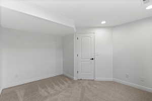 Unfurnished room featuring carpet floors and recessed lighting