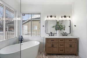 Full bath with a freestanding bath and double vanity - Primary Bath