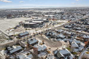 Aerial view of property and surrounding area with nearby suburban area