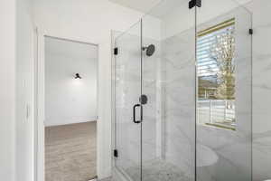 Full bathroom featuring carpet and a marble finish shower