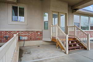 Entrance to property featuring stucco siding and brick siding