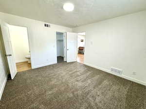 Primary bedroom with walk in closet, personal 1/2 bath and access to laundry/bonus room