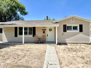 View of front facade featuring a porch and a shingled roof