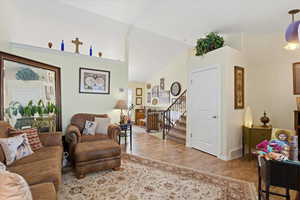 Living room with stairs and light wood finished floors