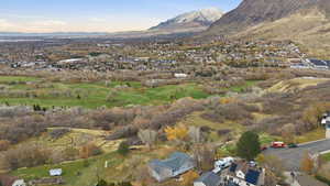 View of property location featuring mountains and nearby suburban area