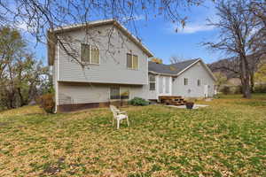 Rear view of property featuring a lawn