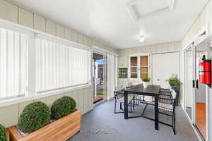 Sunroom featuring french doors and outdoor dining space