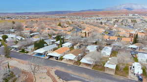 Aerial overview of property's location featuring a mountain backdrop and nearby suburban area