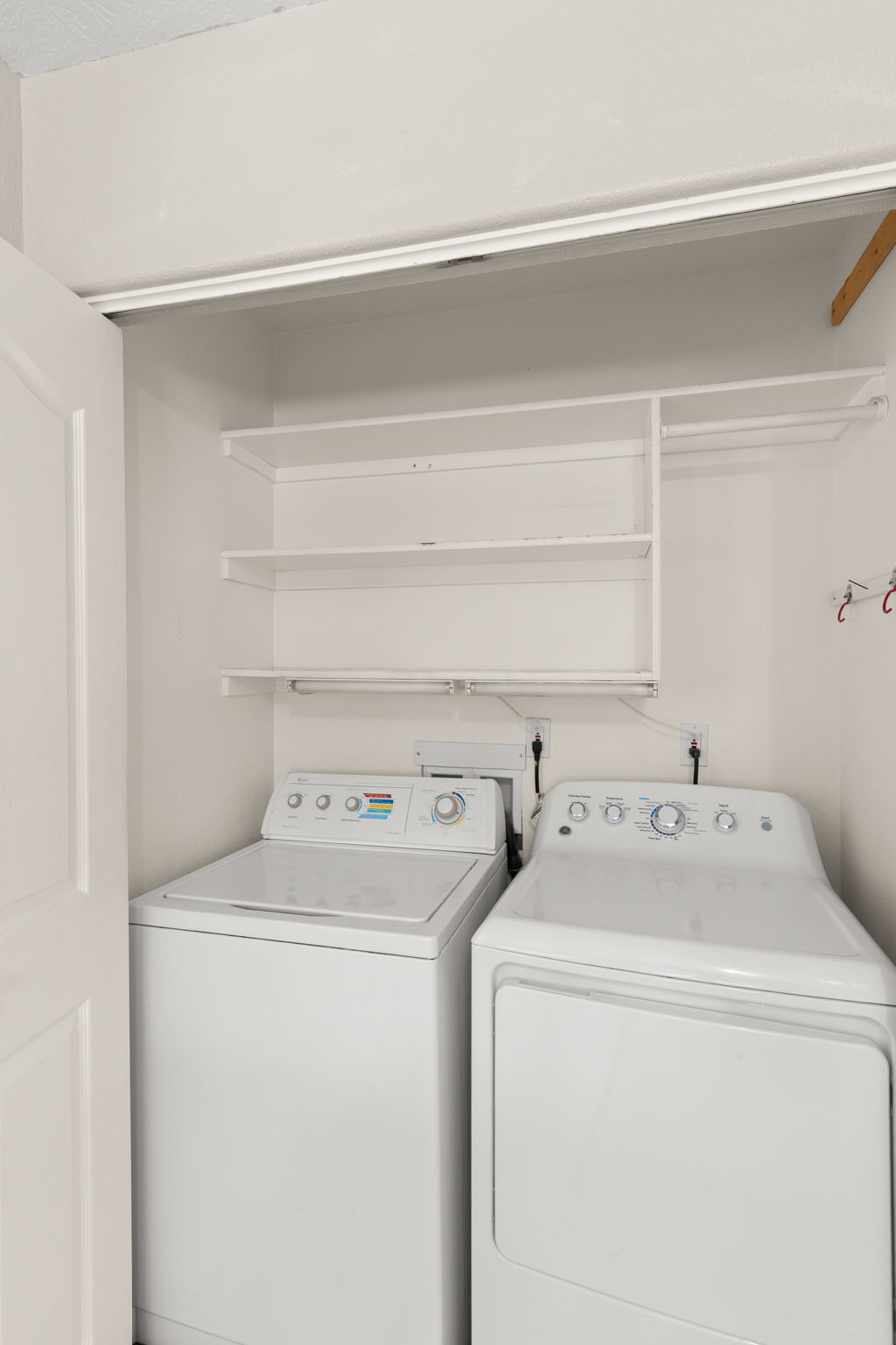 Washroom featuring washing machine and dryer