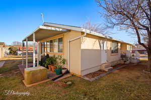 View of property exterior featuring a lawn and stucco siding