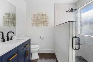 Primary bathroom featuring dual vanity, walk-in shower, and tile flooring