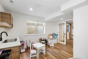 Flex space with dual windowed doors and kitchenette.