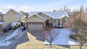 Ranch-style house featuring driveway, stucco siding, an attached garage, brick siding, and a shingled roof