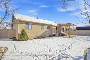Spacious fenced backyard, a pergola, and a patio