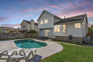 Pool at dusk with a fenced backyard, a patio, and entry steps