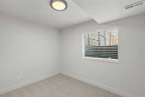 Spare room with carpet and baseboards